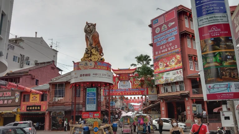 Entrance arch of Jonker Walk in Malacca, Malaysia, featuring a prominent golden tiger statue.
