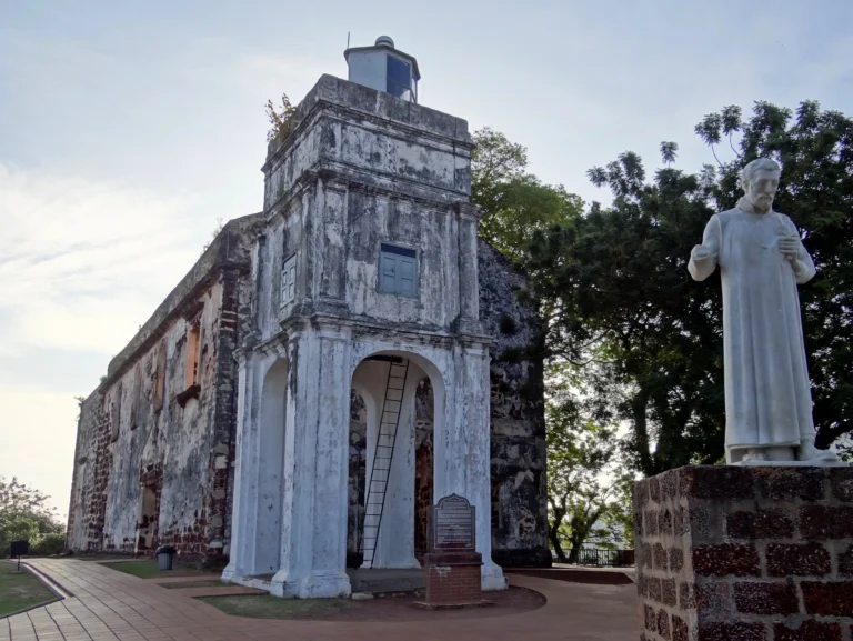 St. Paul's Church in Malacca, with the statue of St. Francis Xavier in the foreground missing its right forearm.